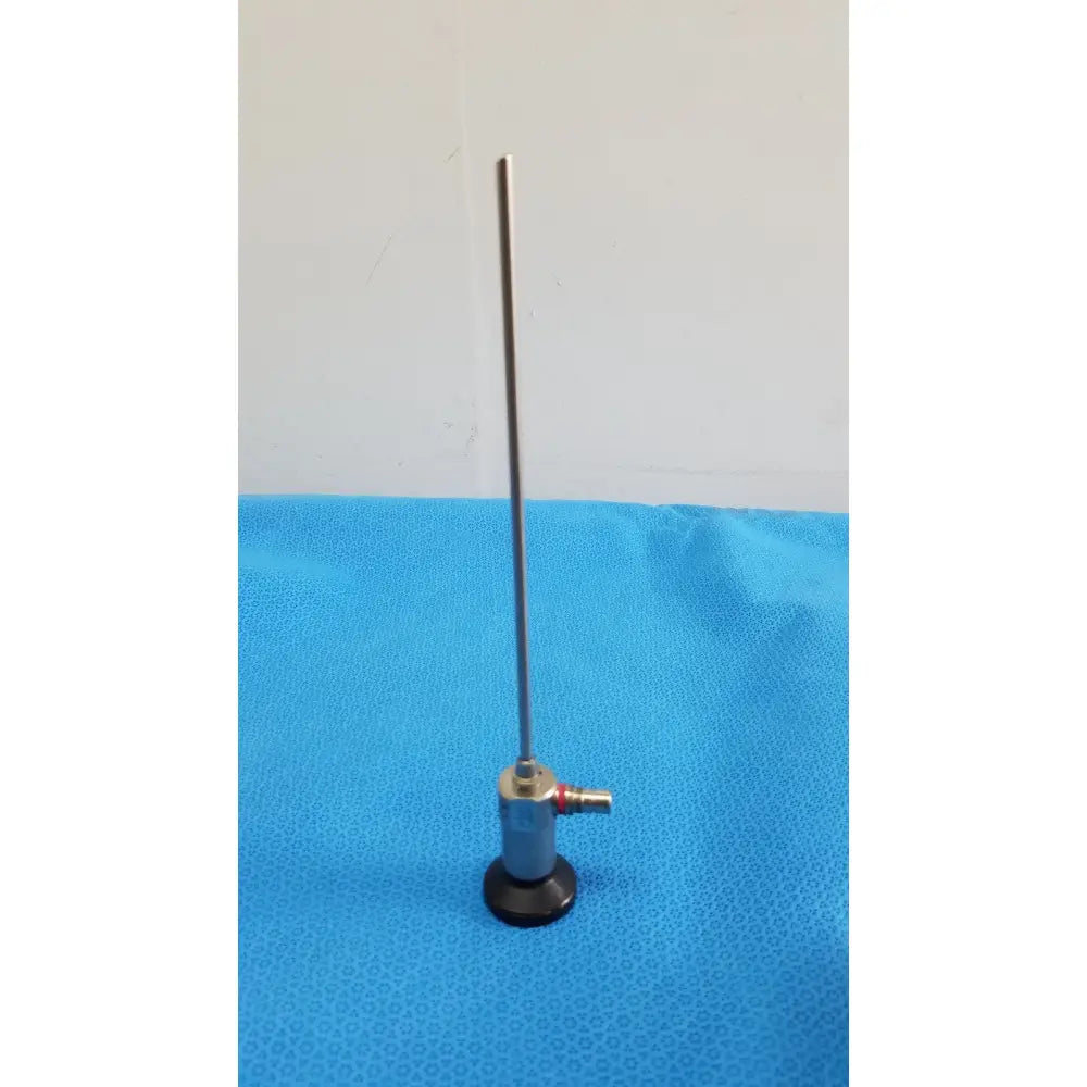 Silver xomed sharpsite autoclavable endoscope with slender metallic shaft and black circular footplate for reuse medical use