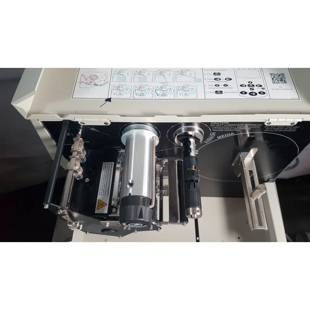 Silver cylindrical spindle with black base and metallic parts on zebra 105sl plus usb ethernet thermal transfer label printer