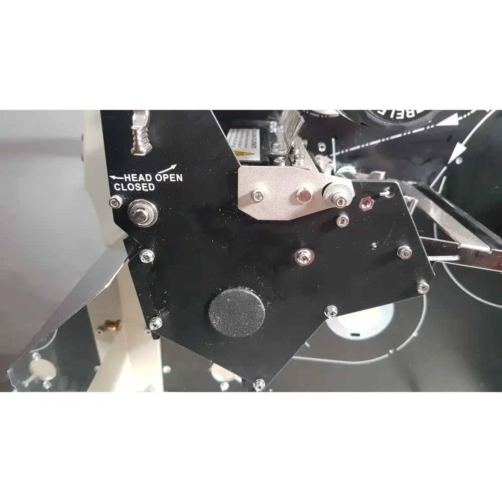 Black metal mechanical component with silver bolts and circular textured pad on zebra 105sl plus usb printer