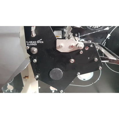 Black metal mechanical component with silver bolts and circular textured pad on zebra 105sl plus usb printer