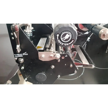 Black industrial zebra 105sl plus usb thermal transfer label printer with metallic components and circular release knob