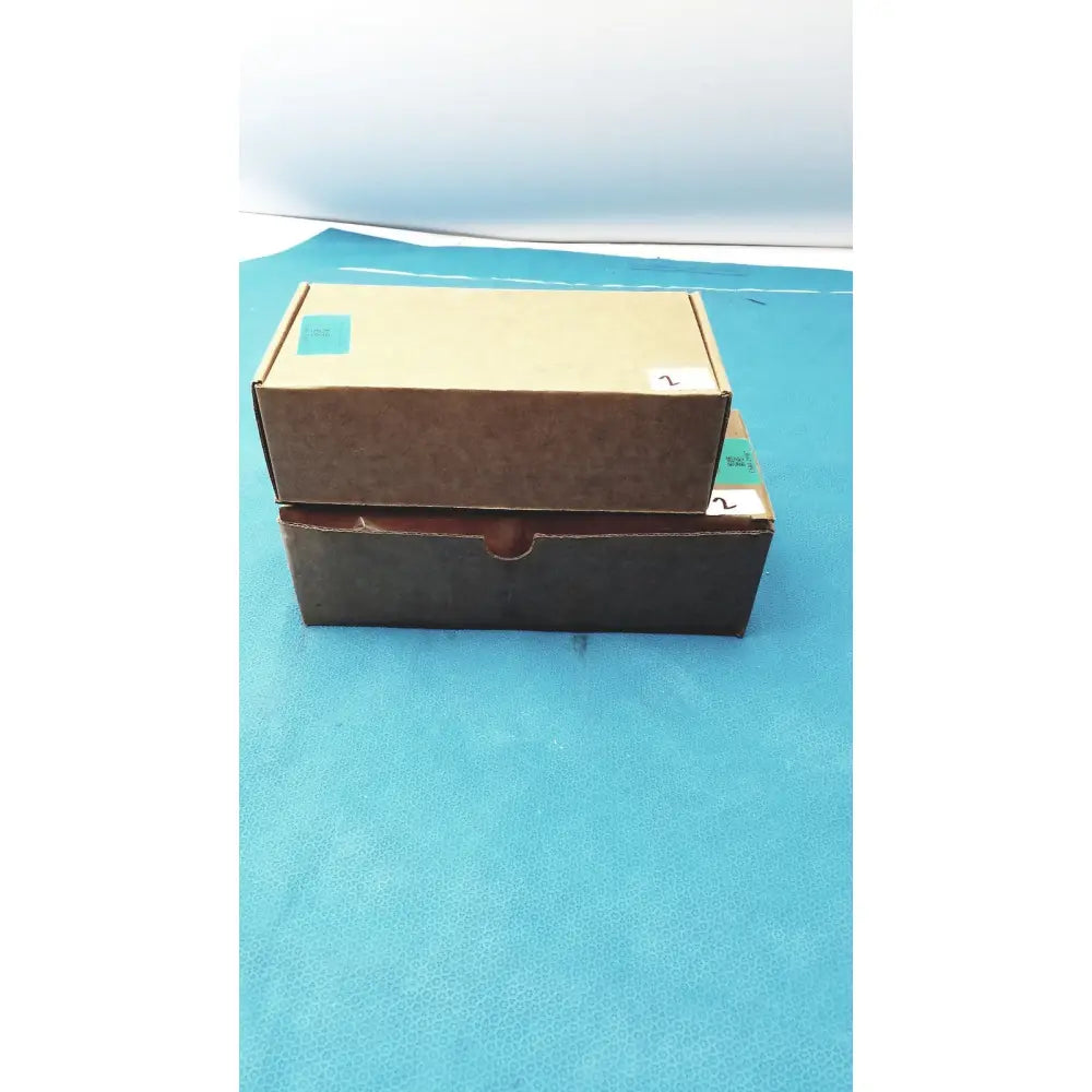 Two stacked cardboard boxes brown and dark with handle for zebra barcode scanner mt2070-sd4d62370wr with charger