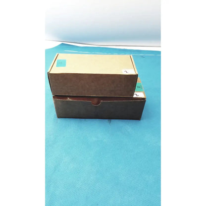 Two stacked cardboard boxes brown and dark with handle for zebra barcode scanner mt2070-sd4d62370wr with charger
