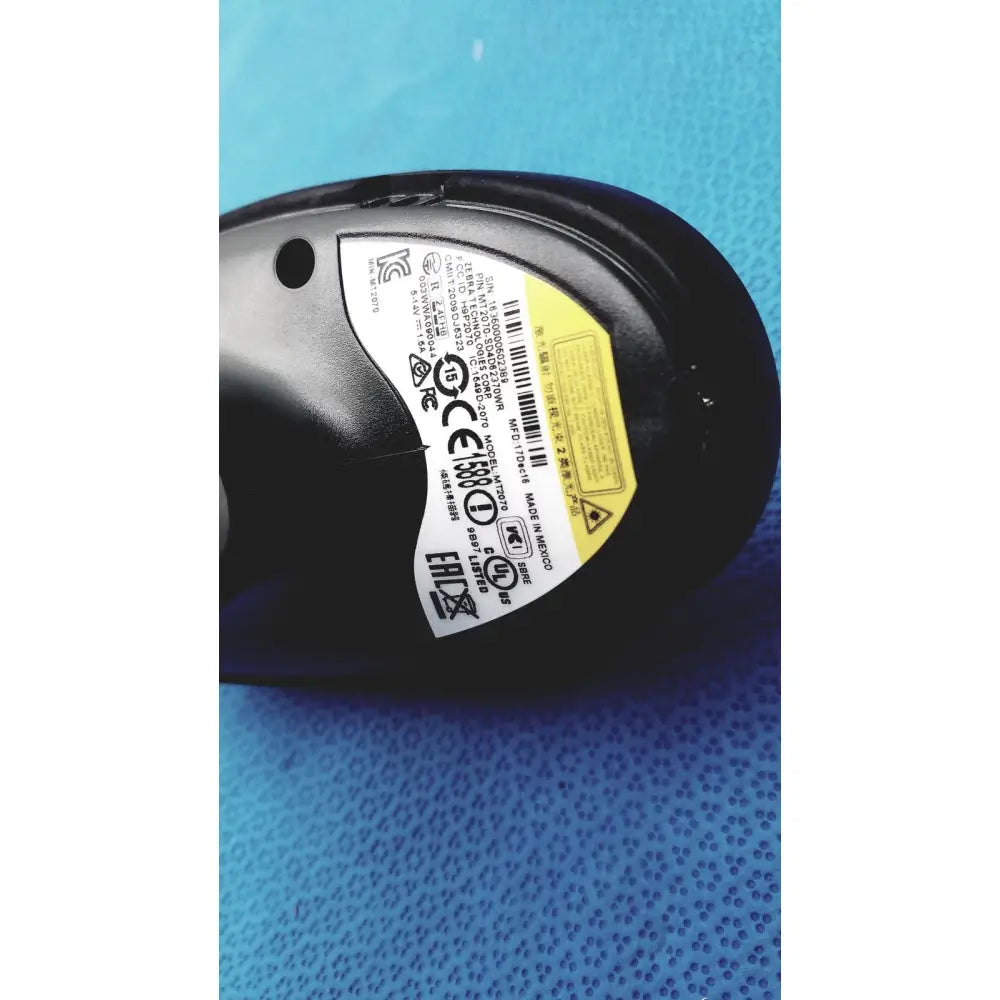 Black ergonomic computer mouse with glossy finish and regulatory label shown on back side of zebra barcode scanner mt2070-sd4d62370wr product