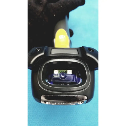 Black zebra barcode scanner mt2070-sd4d62370wr with yellow trigger and visible camera lens in open scanning window