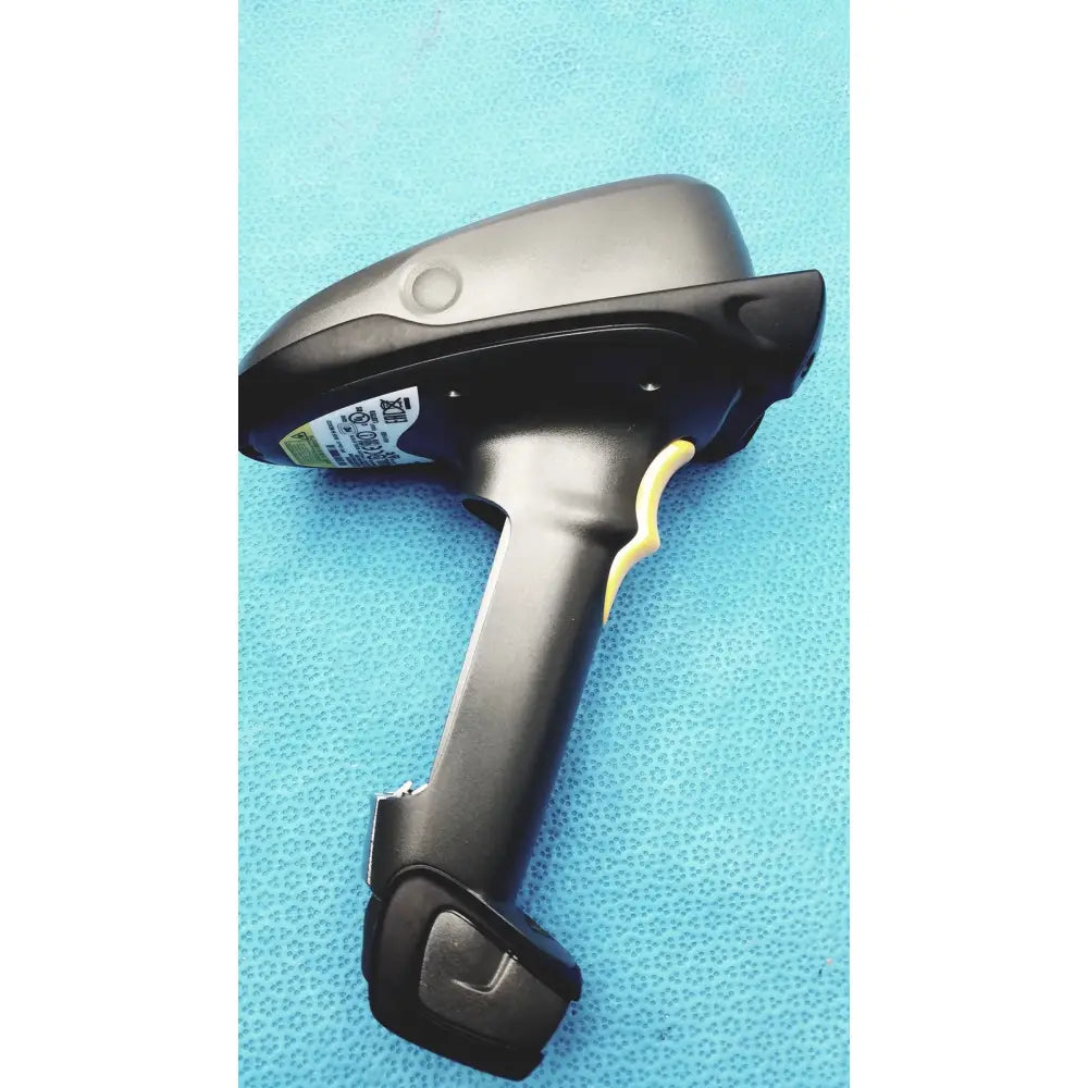 Black zebra barcode scanner mt2070-sd4d62370wr with yellow trigger gray top and battery charger for efficient scanning
