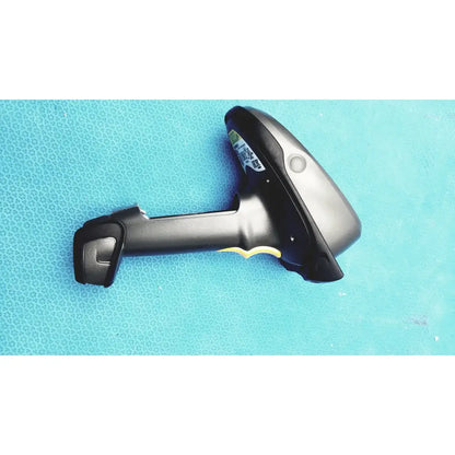 Black and silver zebra barcode scanner mt2070-sd4d62370wr with yellow trigger accent and battery charger visible