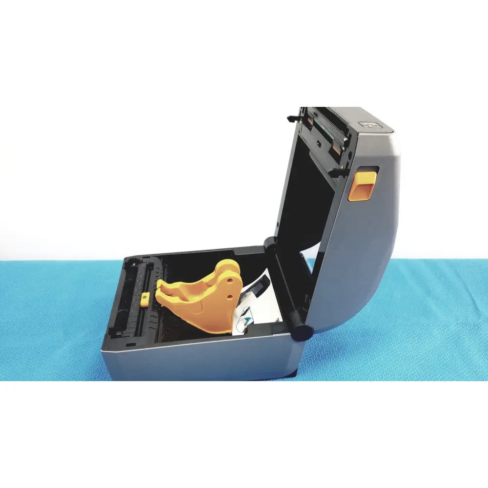 Gray zebra zd620 thermal transfer desktop label printer with yellow plastic component inside its open casing