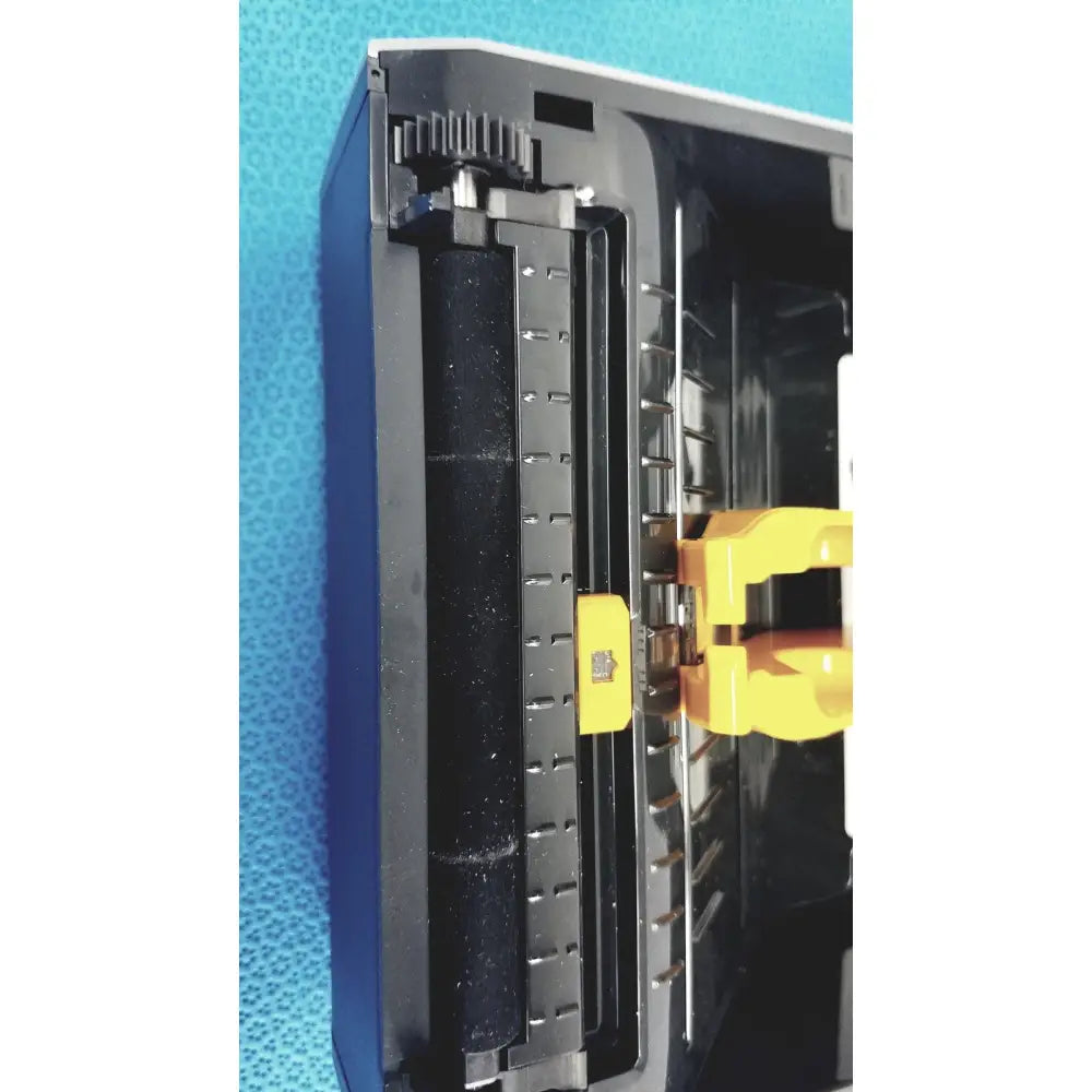 Black plastic printer cartridge with yellow mechanical parts and visible roller for zebra zd620 thermal transfer desktop printer