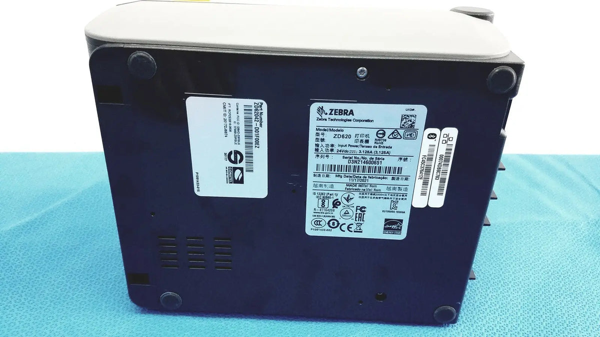 Dark blue zebra zd420 barcode scanner with light gray top and black rubber feet shown with zebra zd620 thermal transfer printer