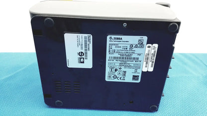 Dark blue zebra zd420 barcode scanner with light gray top and black rubber feet shown with zebra zd620 thermal transfer printer