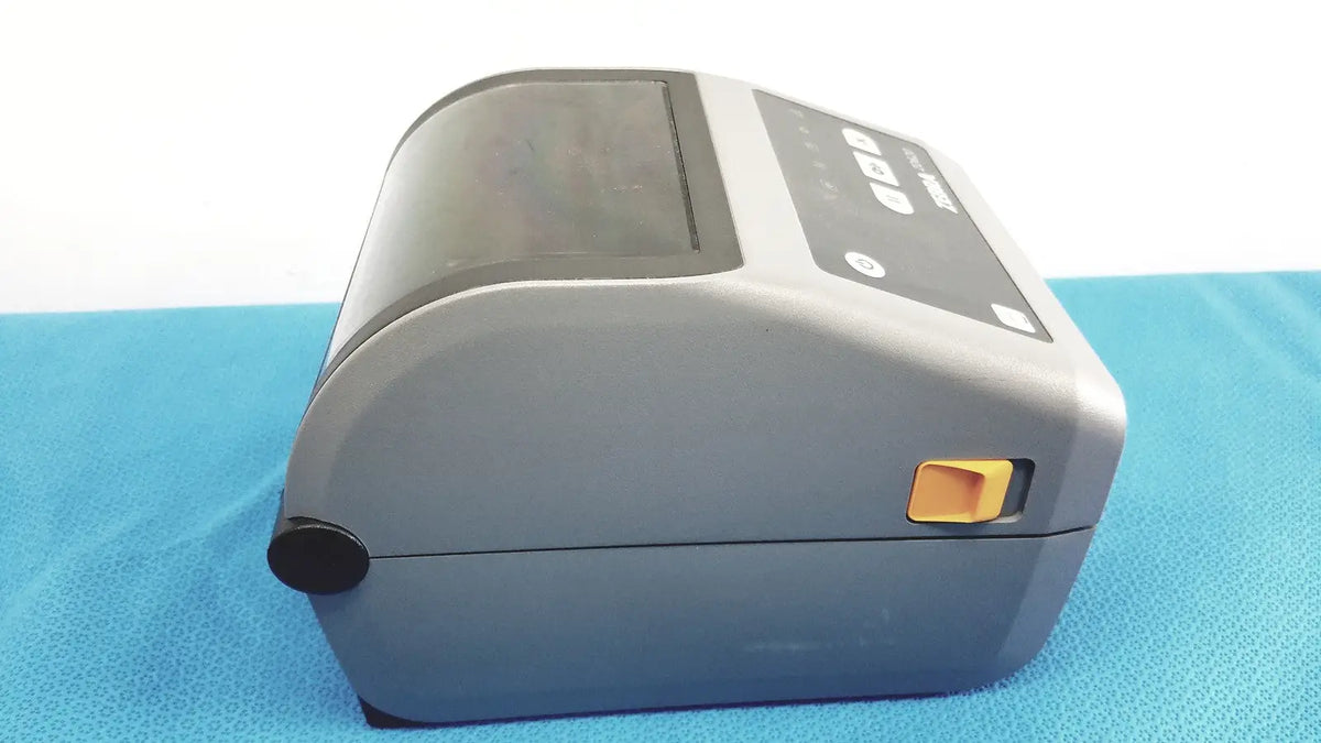 Gray zebra zd620 thermal transfer desktop label printer with black control panel and orange power button