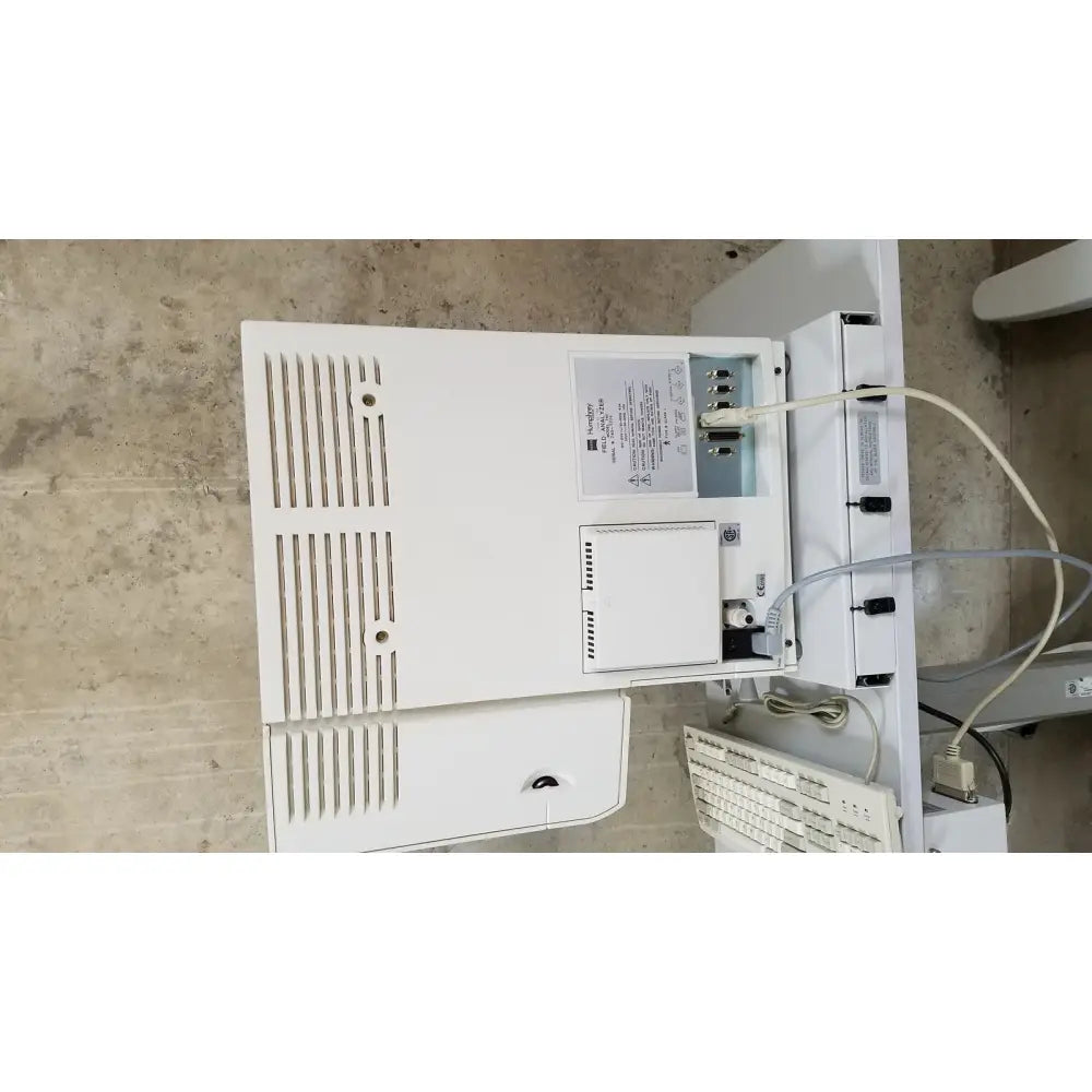 White plastic Zeiss Humphrey visual field analyzer model 740 desktop computer with vertical ventilation slats and attached peripherals