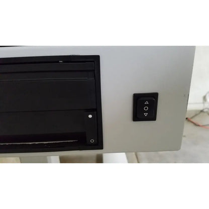 Black rectangular cd dvd drive with matte finish mounted on light gray zeiss humphrey visual field analyzer model 740