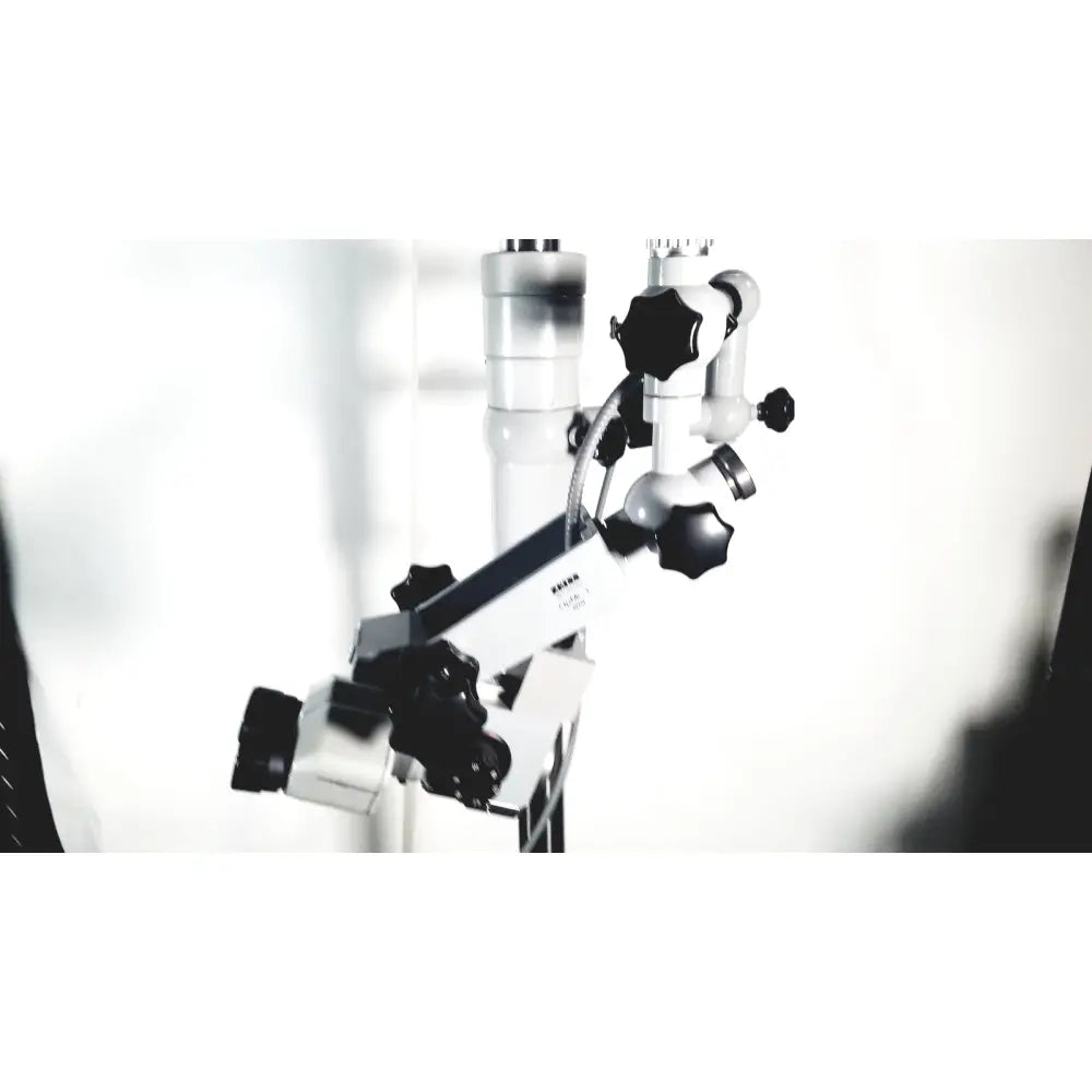 A white and black zeiss opmi-1 prescott’s mark ii surgical microscope with adjustable arms and floor stand