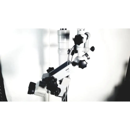 A white and black zeiss opmi-1 prescott’s mark ii surgical microscope with adjustable arms and floor stand