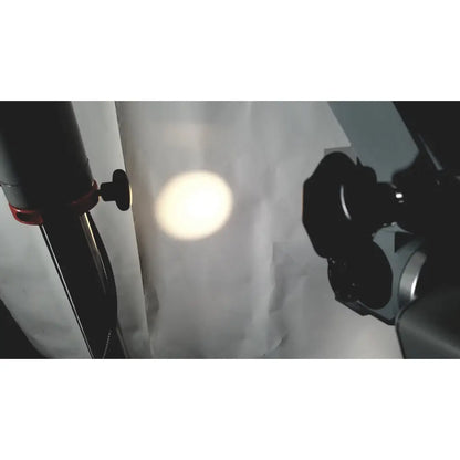 A bright circular studio light illuminates a white backdrop with the zeiss opmi-1 prescotts mark ii on floor stand