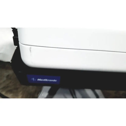 White medtronic zepto precision pulse capsulotomy device with black base and blue logo alongside zepto power console with stand