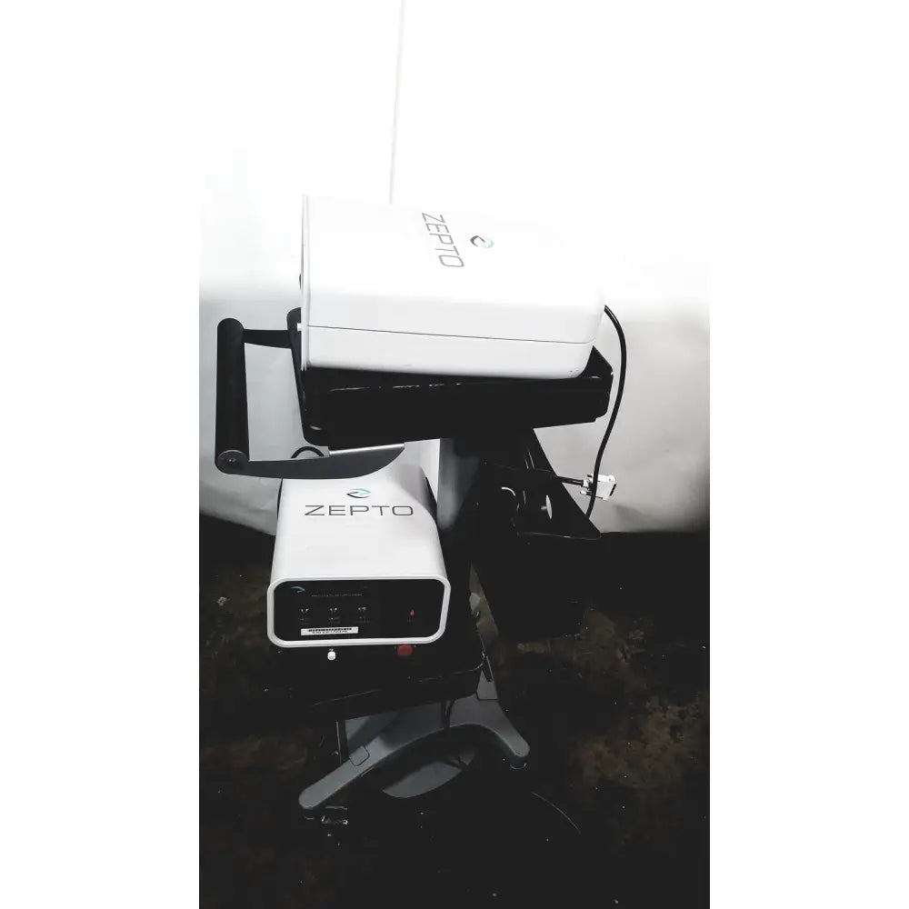 White zepto precision pulse capsulotomy device with sleek rectangular design and black accent zepto power console base
