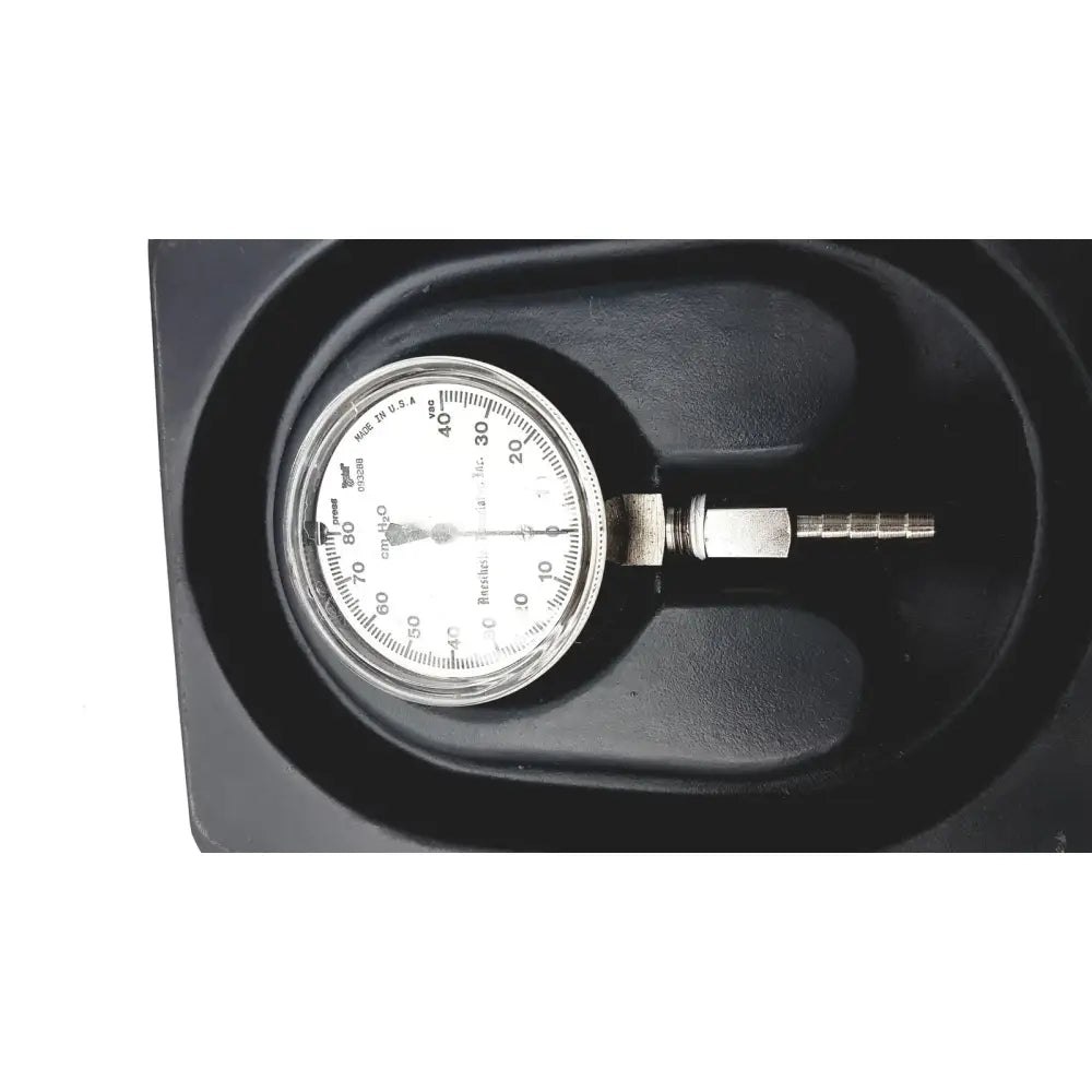 Black plastic housing containing a silver-faced zimmer 1550-20 tourniquet test gauge mmhg with metallic stem