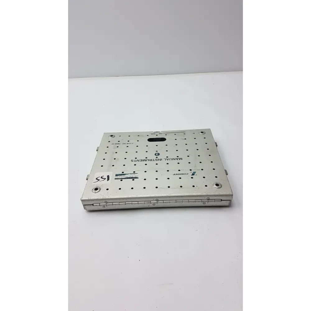 Silver metallic surgical instrument tray with grid holes and engraved text for zimmer fracture management manual case