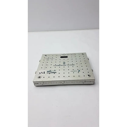 Silver metallic surgical instrument tray with grid holes and engraved text for zimmer fracture management manual case