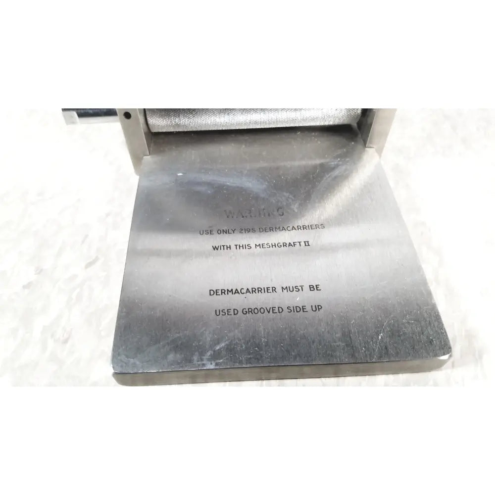 Silver metallic meshgraft dermatome ii 2195-100 with engraved instructions for use and skin graft blades