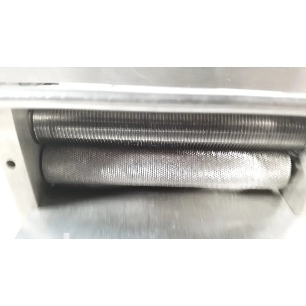 Two parallel ribbed metallic rollers housed in stainless steel casing of zimmer meshgraft dermatome ii 2195-100