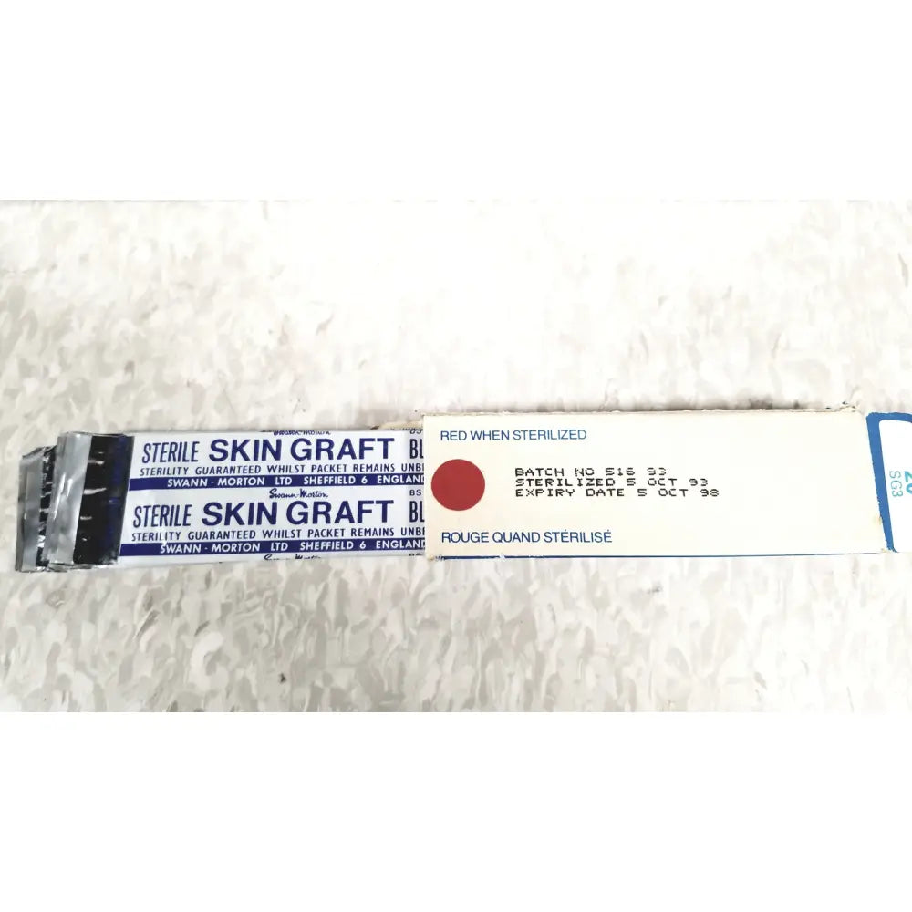 Sterile skin graft package of zimmer meshgraft dermatome ii 2195-100 with white blue labeling and red sterilization indicator
