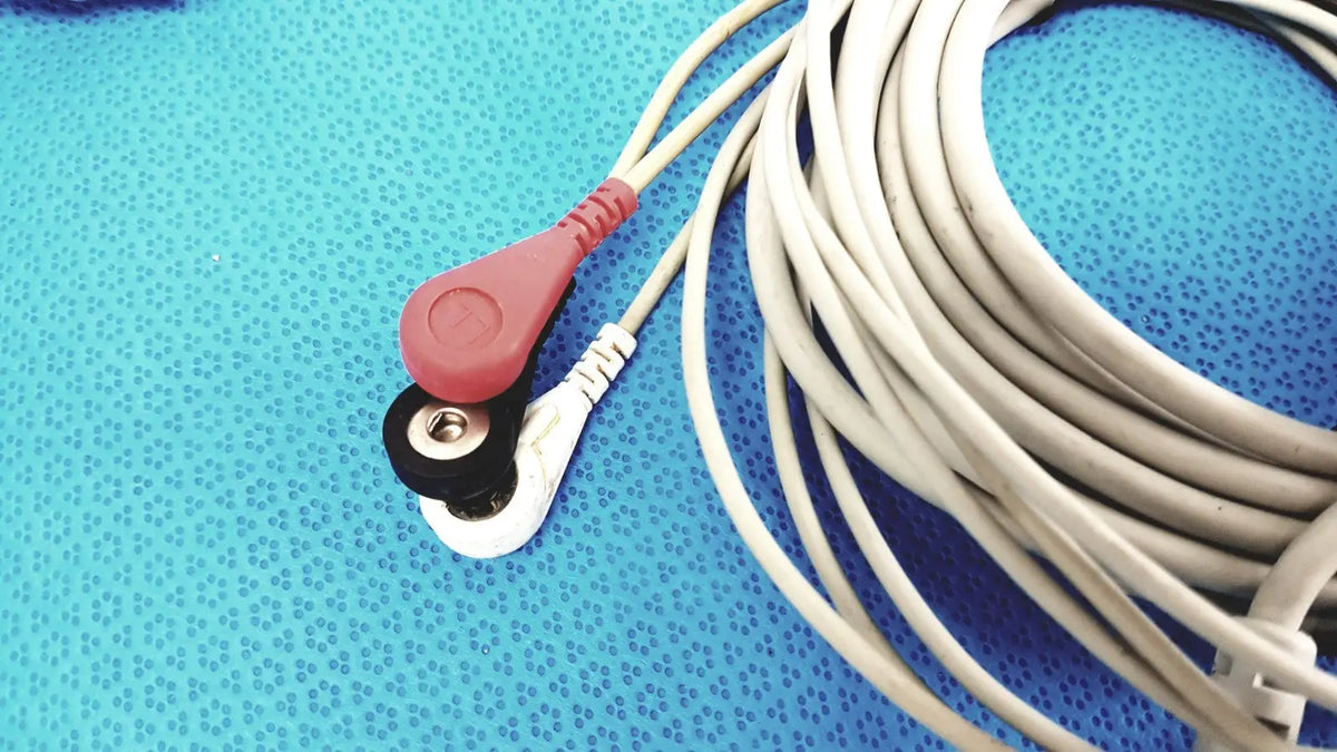 ZOLL 3-lead ECG EKG patient monitoring cable lot of 2 with red and black electrode leads and white cables on blue surface