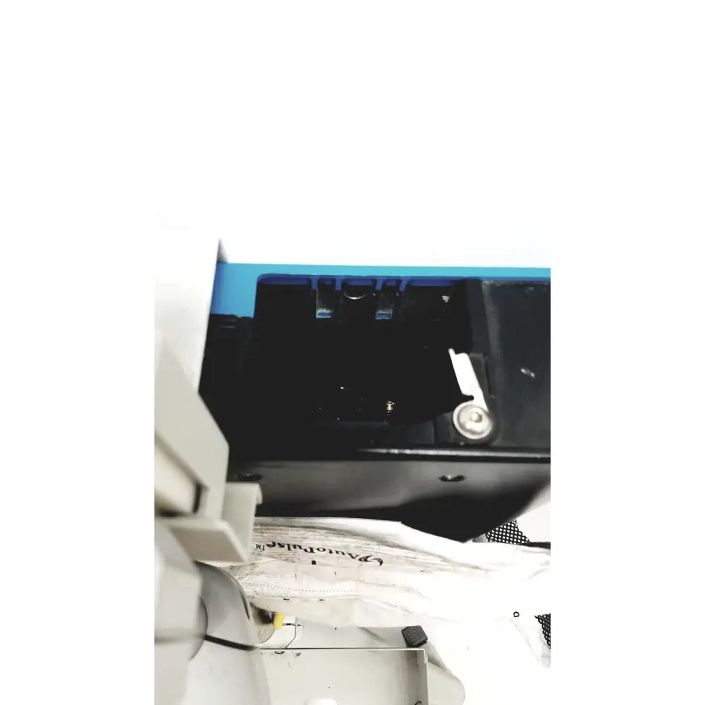 Blue and black plastic zoll autopulse resuscitation system with white circular lifeband on rolling stand for emergency use