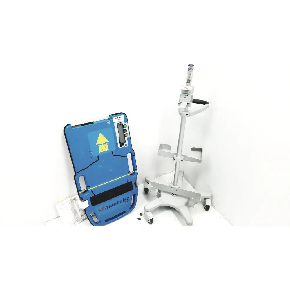 Blue autopulse defibrillator pad with yellow warning symbol and digital display on zoll autopulse resuscitation system