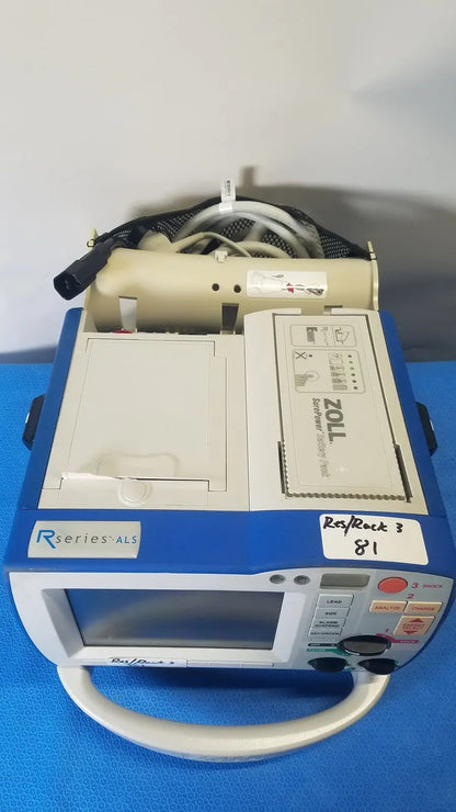 Blue and white zoll r series als patient monitor with beige handle and surepower battery pack for portability