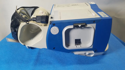 Blue and white zoll aed 3 with mesh bag attached shown with zoll r series als patient monitor and surepower battery pack