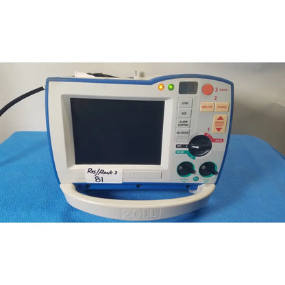 Blue and white zoll r series als patient monitor with digital screen control buttons and surepower battery pack
