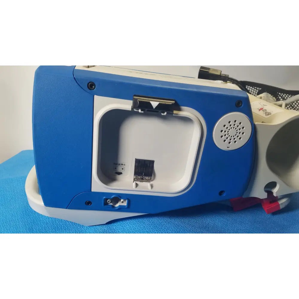Blue and white zoll r series als patient monitor with hinged compartment revealing internal port and surepower battery pack