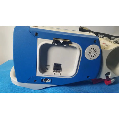 Blue and white zoll r series als patient monitor with hinged compartment revealing internal port and surepower battery pack