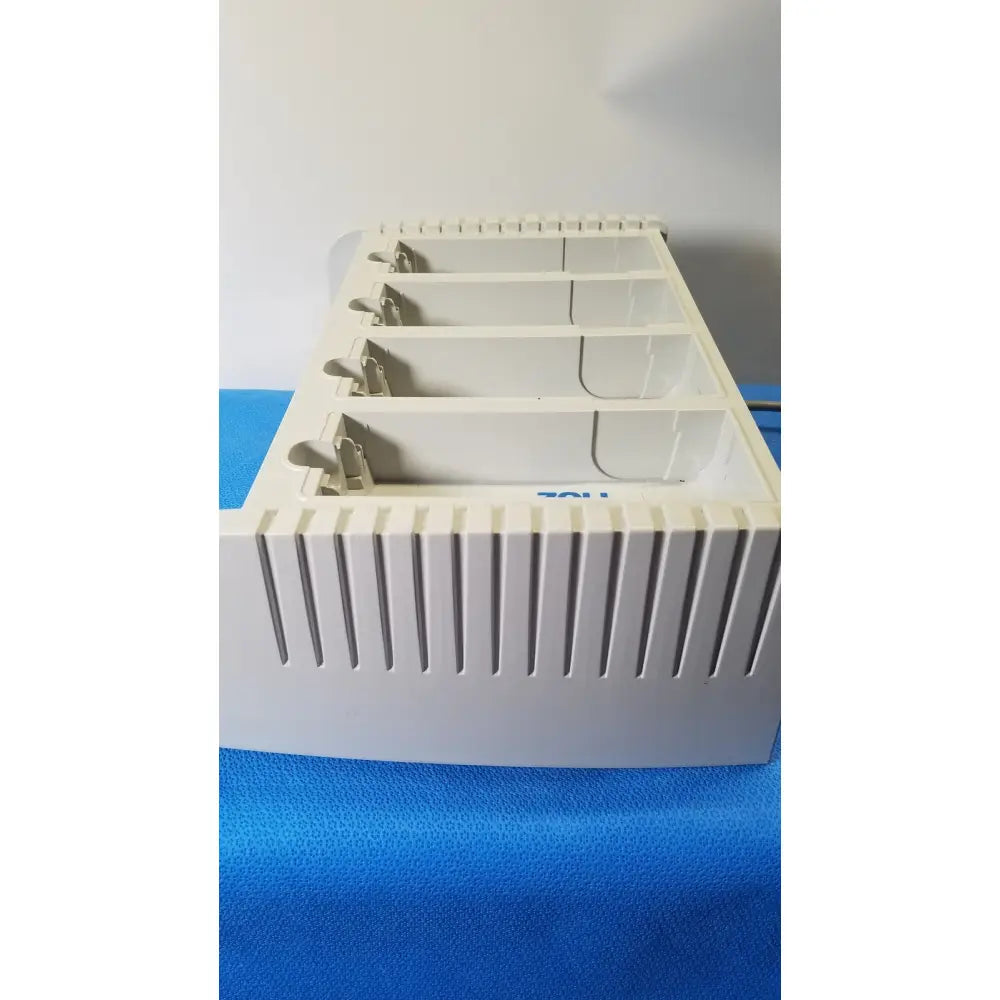 White plastic card holder with four compartments and vertical slits in zoll surepower bay charger station ipx1