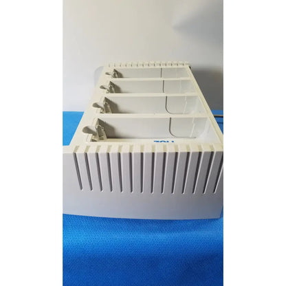 White plastic card holder with four compartments and vertical slits in zoll surepower bay charger station ipx1