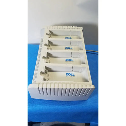 White plastic zoll surepower 4 bay charger station ipx1 with four labeled zoll slots for efficient battery charging
